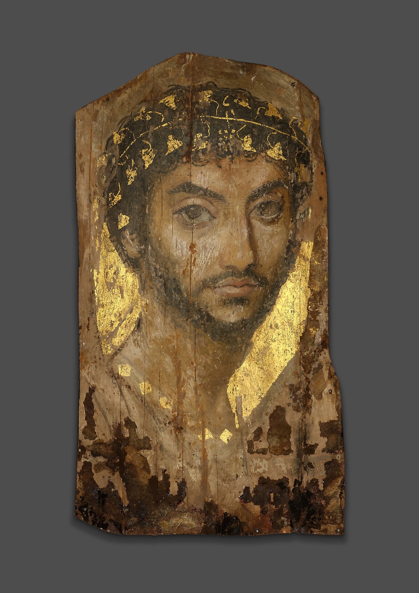 Mummy portrait of a man wearing an ivy wreath, Roman Egypt, c. 101 CE — wreath, gold, gaze: codes at work for 1,900 years